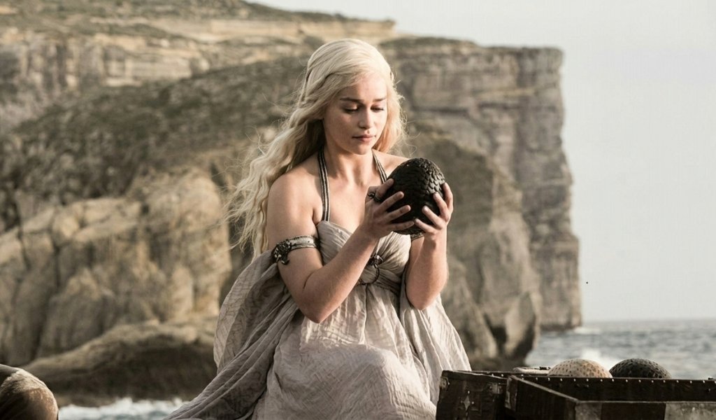 Daenerys Targaryen holding her stone-like dragon eggs in Game of Thrones
