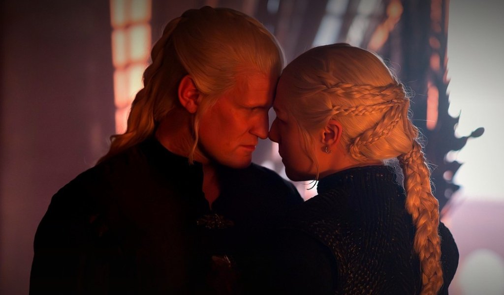 Close-up shot of Daemon Targaryen and Queen Rhaenyra Targaryen touching foreheads with warm dramatic lighting in House of the Dragon Season 3